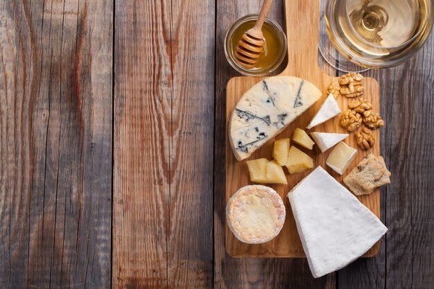 Tasting cheese dish on a wooden background.