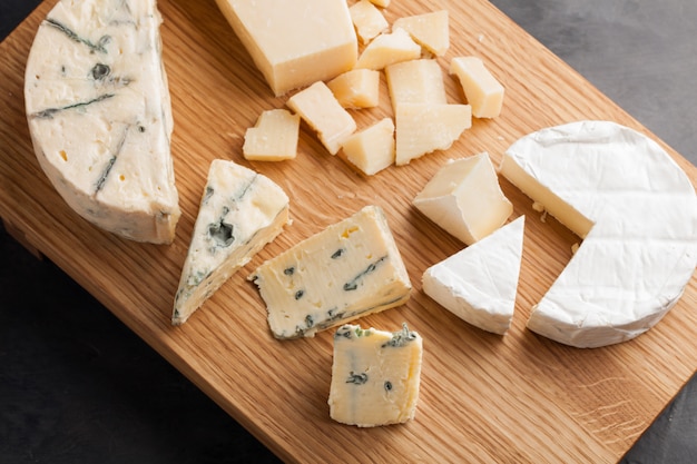 Tasting cheese dish on a wooden plate.