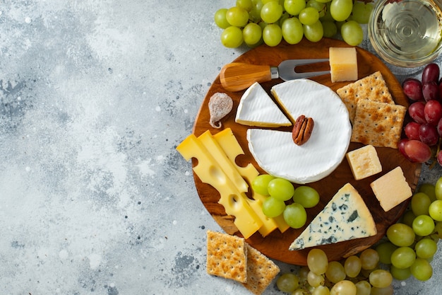 Tasting cheese dish on a wooden plate.