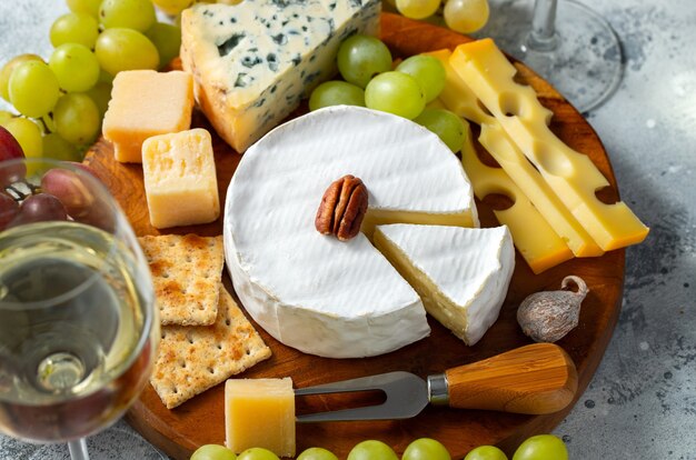 Tasting cheese dish on a wooden plate.