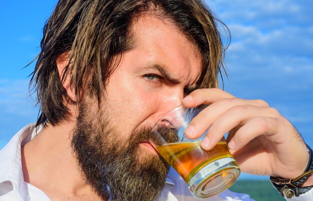 Tasting and degustation. Bearded man drinking cognac. Handsome Man with glass of brandy.