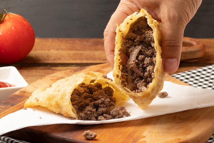 Photo tasting delicious brazilian pastel of meat selective focus