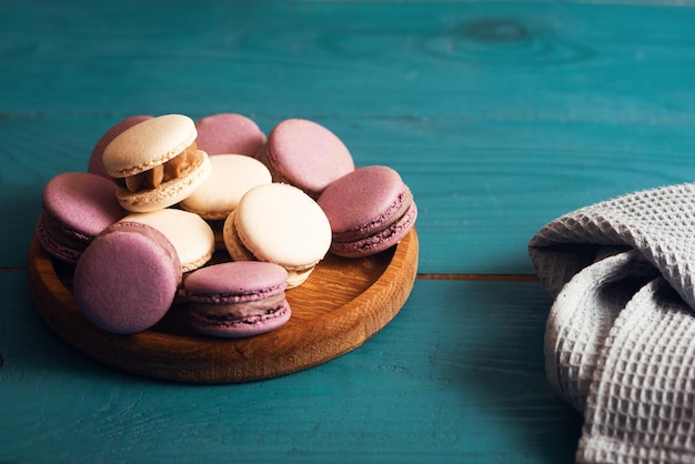 Tasty almond macarons on the blue wood surface Vintage romantic style