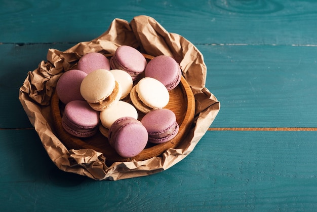 Tasty almond macarons on the blue wood surface Vintage romantic style