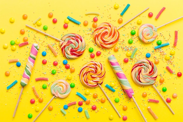 Tasty appetizing Party Accessories Happy Birthday Sweet Different types of candies on colored background copy space Colorful birthday party background