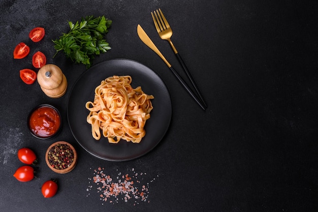 Tasty appetizing pasta tagliatelle spaghetti with tomato sauce and parmesan