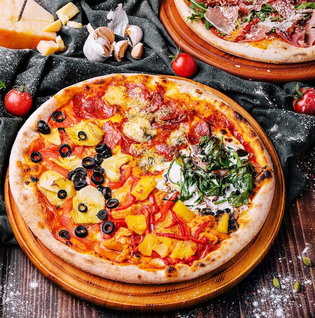 Tasty assorted pizzas on a wooden background