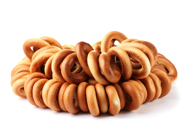 Tasty bagels on rope isolated on white