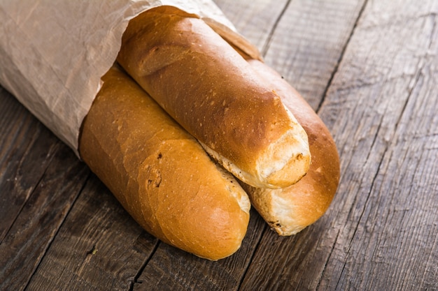 Tasty baguette on wooden table