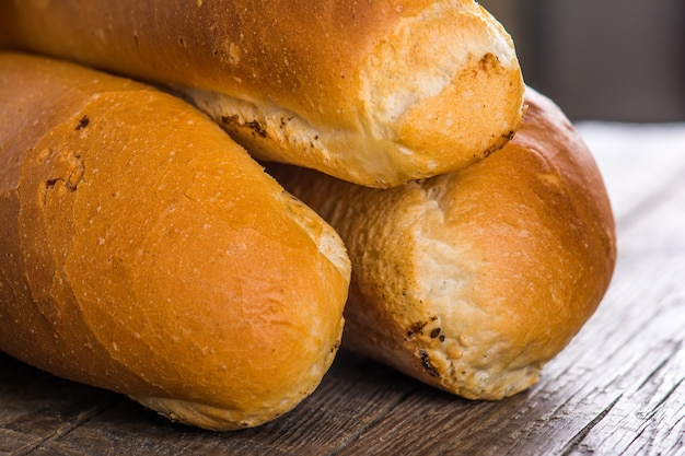 Tasty baguette on wooden table