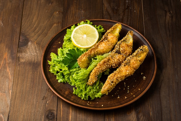 Tasty baked fish on plate table close-up