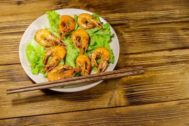 Tasty baked shrimps on a wooden table