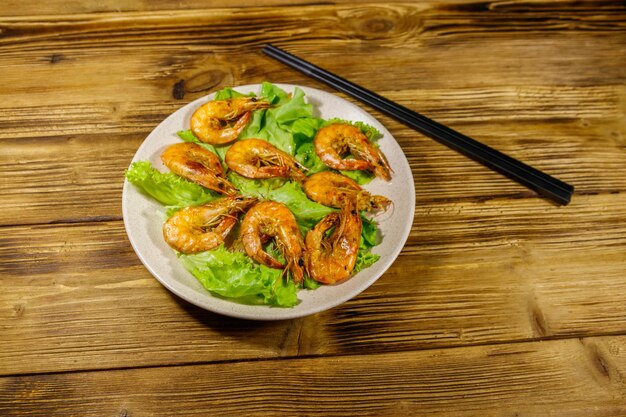 Tasty baked shrimps on a wooden table