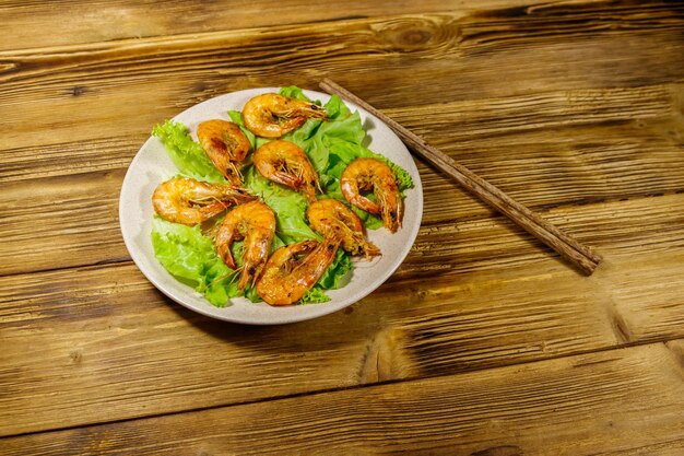 Tasty baked shrimps on a wooden table