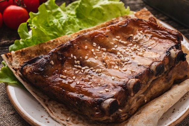 Tasty barbecue pork ribs on a plate. Closeup