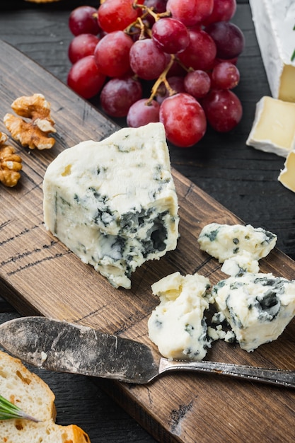 Tasty blue cheese set, on black wooden table