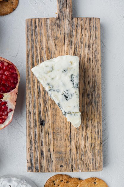 Tasty blue cheese set, on white background, flat lay