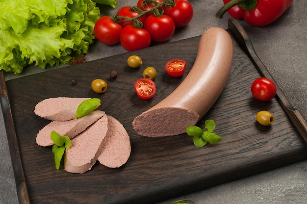 Photo tasty boiled sausage from offal on a dark wooden background