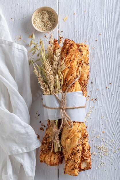 Tasty bread sticks on table in rustic kitchen