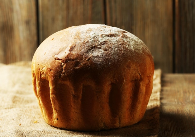 Tasty bread on table on wooden background