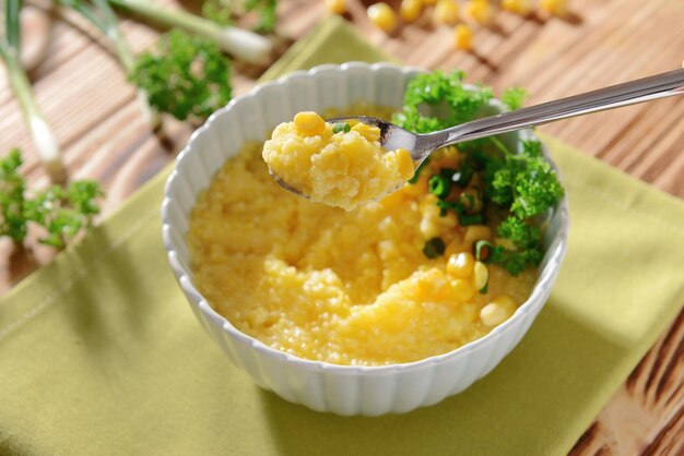 Tasty breakfast of cornmeal porridge on napkin closeup