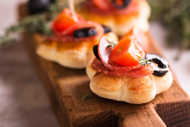 Tasty breakfast toasts on wooden board