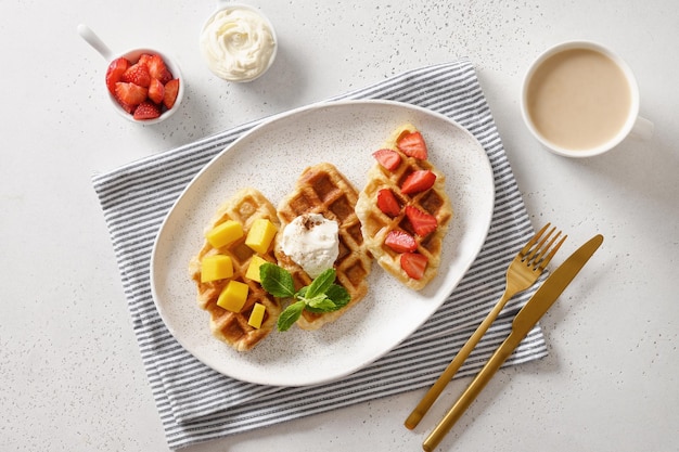 Tasty breakfast with croffles and morning coffee strawberries Croissant as waffle