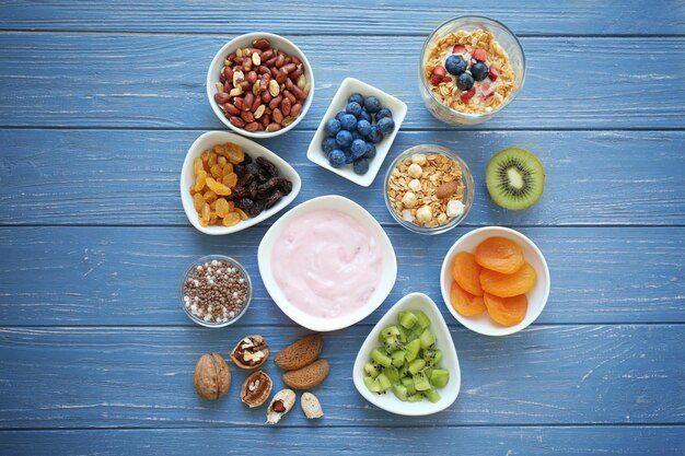 Tasty breakfast with yogurt on table