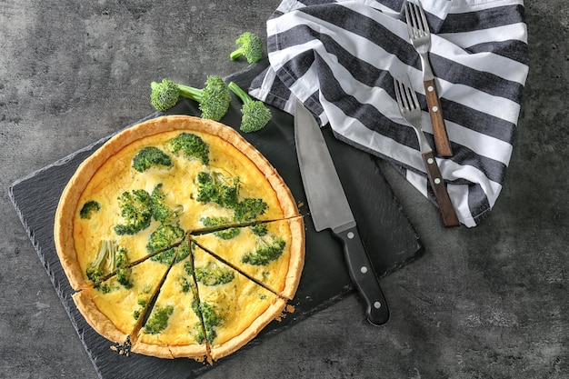 Tasty broccoli quiche on table