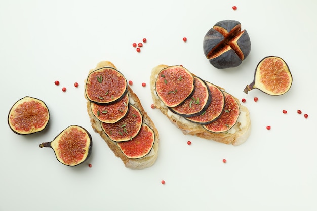 Tasty bruschetta with fig on white background