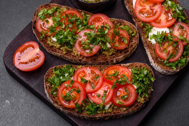 Tasty bruschetta with tomatoes mozzarella basil spices and herbs