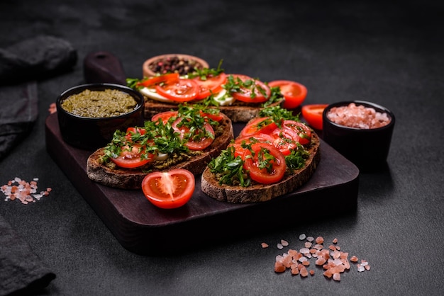 Tasty bruschetta with tomatoes mozzarella basil spices and herbs