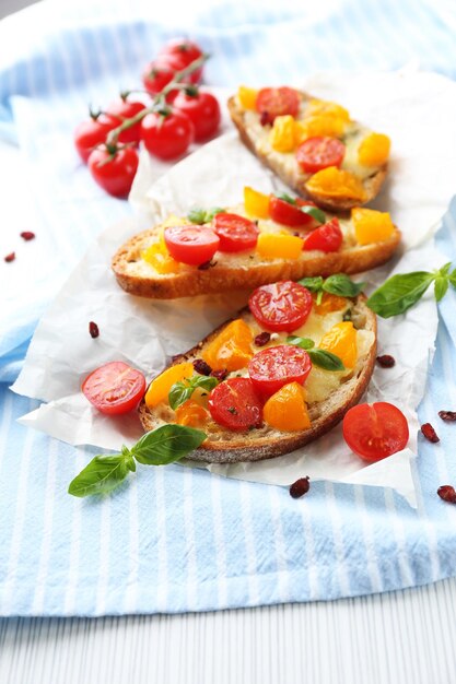 Tasty bruschetta with tomatoes on table