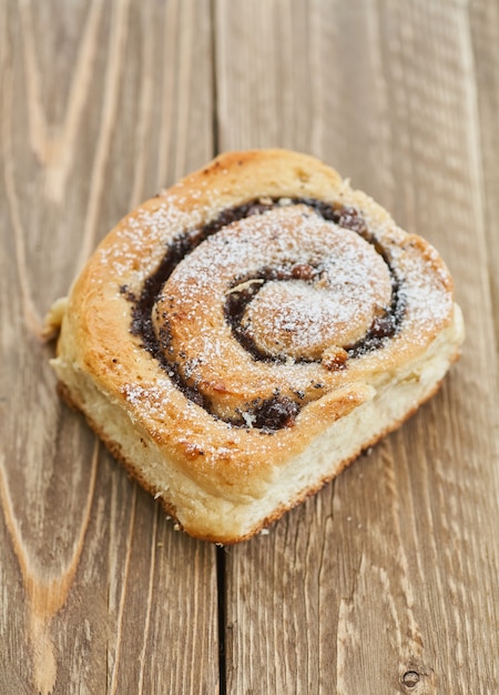 Tasty buns with raisins on a brown rustic wooden table. fresh bakery. breakfast. bread. top view