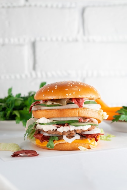 Tasty burger on a light wooden table