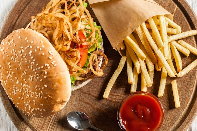 Tasty burger with french fries and ketchup