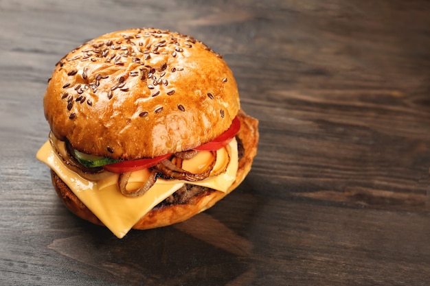 Tasty burger on wooden surface