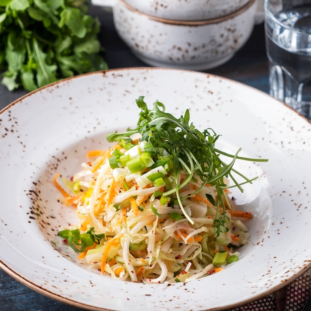 Tasty cabbage salad with carrots and onion.