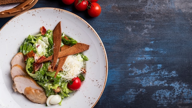 Tasty Caesar salad with chicken and vegetables