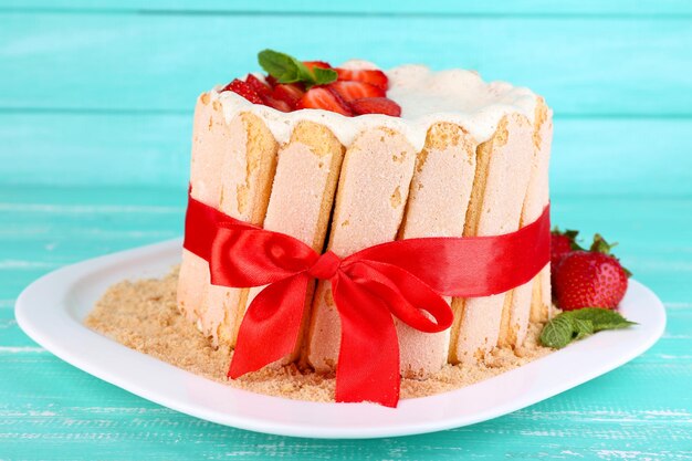 Tasty cake Charlotte with fresh strawberries on wooden table