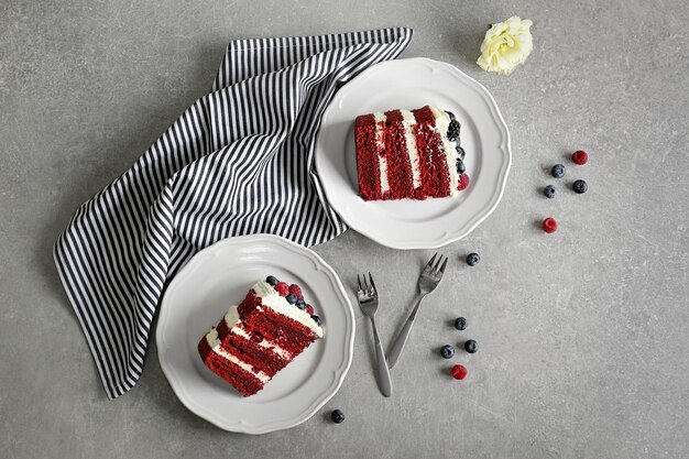 Tasty cake slices with berries on table