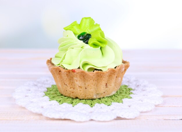 Tasty cake on table on light background