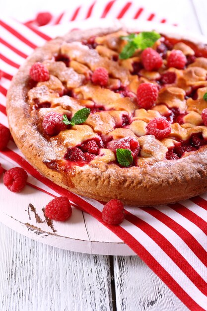 Tasty cake with berries on table close-up