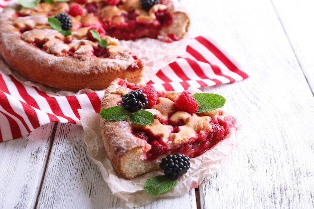 Tasty cake with berries on table closeup