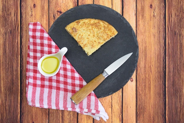 Tasty cake with an egg yolk and oil on a wooden table