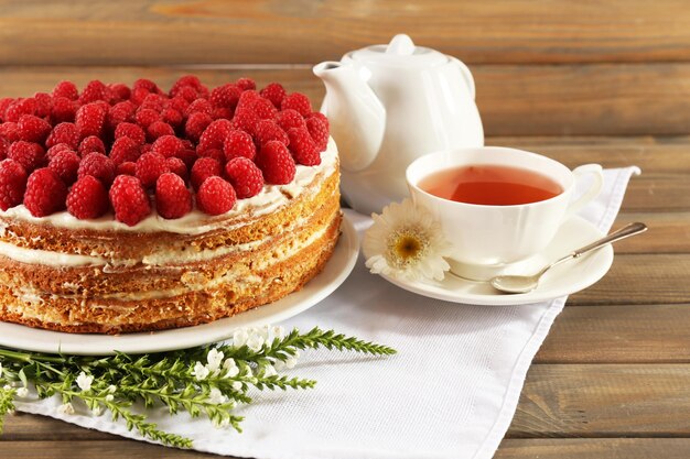 Tasty cake with fresh berries on wooden table