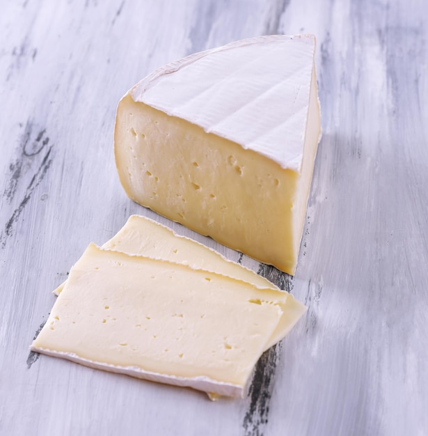 Tasty Camembert cheese on wooden table