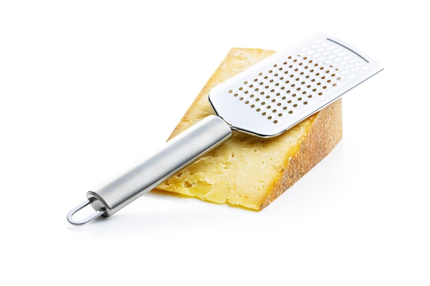 tasty cheese block and cheese grater isolated on white background