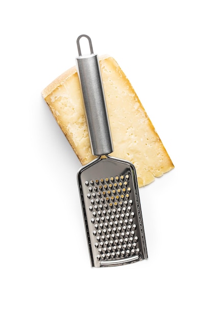 tasty cheese block and cheese grater isolated on white background