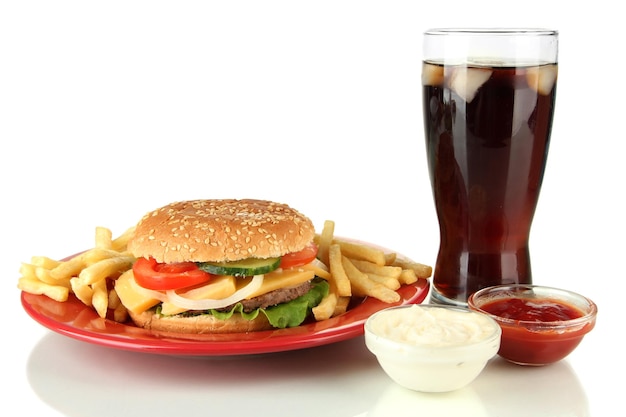 Tasty cheeseburger with fried potatoes and cold drink isolated on white